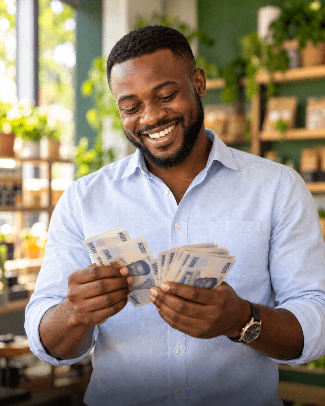 A smiling man counting money